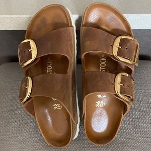 Brown leather Birkenstocks with gold buckle